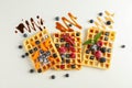 Flat lay composition with belgian waffles and different toppings