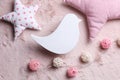 Flat lay composition with bird shaped child`s night lamp on pink fabric