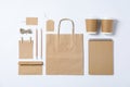 Flat lay composition with blank stationery, paper cups and bag on white background