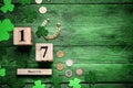 Flat lay composition with block calendar on green wooden table, space for text. Saint Patrick`s Day celebration Royalty Free Stock Photo