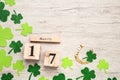 Flat lay composition with block calendar on white wooden table, space for text. Saint Patrick`s Day celebration Royalty Free Stock Photo