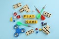 Flat lay composition of blocks with words Play Game on light blue background