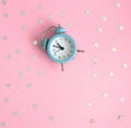 Flat Lay Composition with Blue Clock on a Pink ideal for Banner, Invitation, Card.