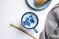 Flat lay composition with blue matcha latte on white table