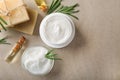 Flat lay composition with body cream, soap and essential oil on light background