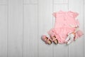 Flat lay composition with bodysuit and space for text on wooden background. Royalty Free Stock Photo