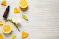 Flat lay composition with bottle of citrus essential oil on white wooden background. Space for text Royalty Free Stock Photo