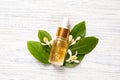 Flat lay composition with bottle of citrus essential oil on wooden background