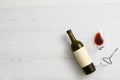 Flat lay composition with bottle of wine and elegant glass on white wooden background Royalty Free Stock Photo