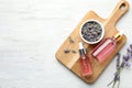 Flat lay composition with bottles of natural lavender essential oil on white wooden background Royalty Free Stock Photo