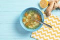 Flat lay composition with bowl of fresh homemade soup to cure flu