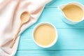 Flat lay composition with bowl and jug of condensed milk Royalty Free Stock Photo