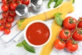 Flat lay composition with bowl of sauce, pasta and tomatoes Royalty Free Stock Photo