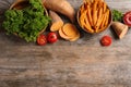 Flat lay composition with bowl of sweet potato fries on wooden background Royalty Free Stock Photo