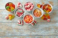 Flat lay composition with bowls of different jelly candies on wooden background Royalty Free Stock Photo