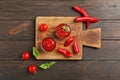 Flat lay composition with bowls of spicy chili sauce and cutting board