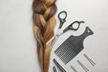 Flat lay composition with braid and hairdresser`s tools Royalty Free Stock Photo