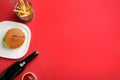 Flat lay composition with burger, French fries and space for text on color background. Traditional food Royalty Free Stock Photo