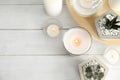 Flat lay composition with burning aromatic candles and plants on wooden table Royalty Free Stock Photo