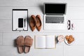 Flat lay composition with business supplies and home accessories on white wooden floor. Concept of balance between work and life Royalty Free Stock Photo