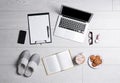 Flat lay composition with business supplies and home accessories on white wooden floor. Concept of balance between work and life Royalty Free Stock Photo