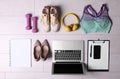 Flat lay composition with business supplies and sport equipment on white wooden floor. Concept of balance between work and life Royalty Free Stock Photo