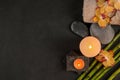 Flat lay composition with candles and spa stones on dark table Royalty Free Stock Photo