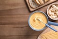 Flat lay composition with cheese fondue and bread on wooden table Royalty Free Stock Photo