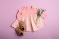 Flat lay composition with child`s clothes, booties and flowers on background Royalty Free Stock Photo