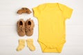 Flat lay composition with child`s clothes and booties on white table Royalty Free Stock Photo