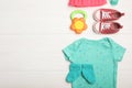 Flat lay composition with child`s clothes and booties on white table, space for text Royalty Free Stock Photo