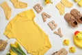 Flat lay composition with child`s clothes and word Baby on white table Royalty Free Stock Photo