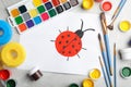 Flat lay composition with child`s painting of ladybug on table Royalty Free Stock Photo