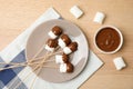 Flat lay composition with chocolate fondue in bowl and marshmallows