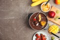 Flat lay composition with chocolate fondue in pot, fruits and space for text