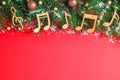 Flat lay composition with Christmas  and music notes on red background, space for text Royalty Free Stock Photo