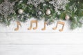 Flat lay composition with Christmas decor and music notes on white wooden table Royalty Free Stock Photo