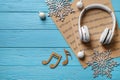 Flat lay composition with Christmas decorations, headphones and music sheets on blue wooden table Royalty Free Stock Photo