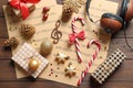 Flat lay composition with Christmas decorations, music sheets and headphones Royalty Free Stock Photo