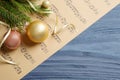 Flat lay composition with Christmas decorations and music sheets on wooden table. Space for text Royalty Free Stock Photo