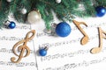 Flat lay composition with Christmas decorations and  music notes on sheets Royalty Free Stock Photo