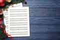 Flat lay composition with Christmas music sheets on blue wooden background, space for text Royalty Free Stock Photo