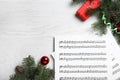 Flat lay composition with Christmas music sheets on white wooden background, space for text Royalty Free Stock Photo