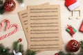 Flat lay composition with Christmas music sheets on wooden background Royalty Free Stock Photo