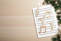 Flat lay composition with Christmas music sheets on wooden background. Space for text Royalty Free Stock Photo