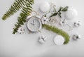 Flat lay composition with clock, burning candles, cotton flowers and tropical leaves on white background Royalty Free Stock Photo