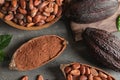 Flat lay composition with cocoa pods, beans and powder on grey Royalty Free Stock Photo