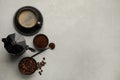 Flat lay composition with coffee grounds and roasted beans on light table, space for text Royalty Free Stock Photo