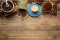 Flat lay composition with coffee grounds and roasted beans on wooden table, space for text Royalty Free Stock Photo