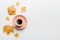 Flat lay composition with colorful Autumn cup of coffee and leaves on a color background. top view Royalty Free Stock Photo